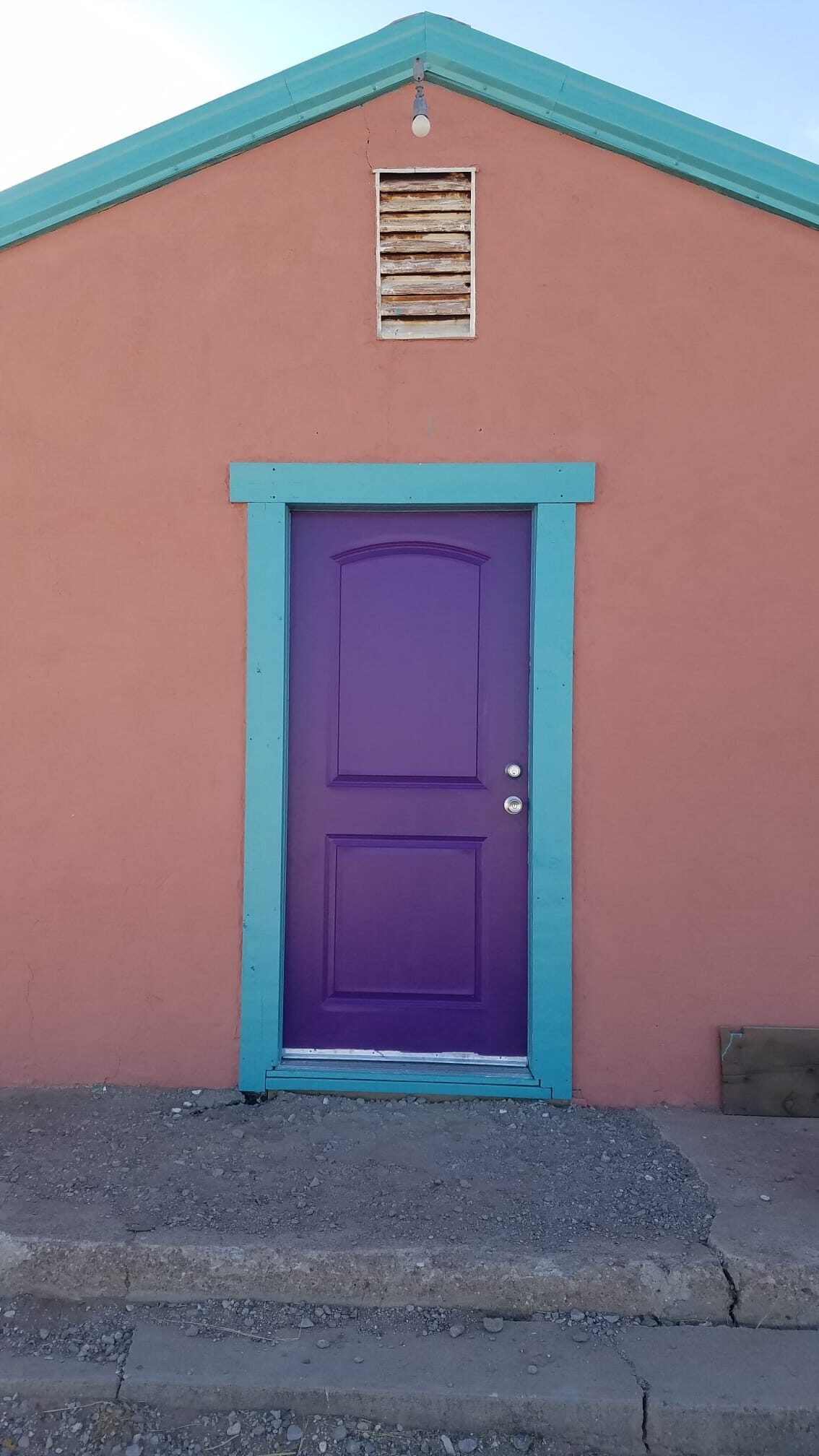 front of the building featuring a purple door